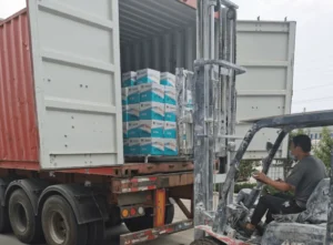 Forklift loading packaged goods into a shipping container