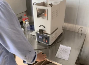 Joobond technician operating laboratory testing equipment